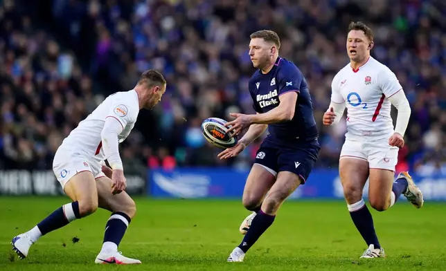 Scotland's Finn Russell, center, in action during the Six Nations rugby union match between Scotland and England in Edinburgh, Scotland, Saturday Feb. 14, 2026. (Jane Barlow/PA via AP)
