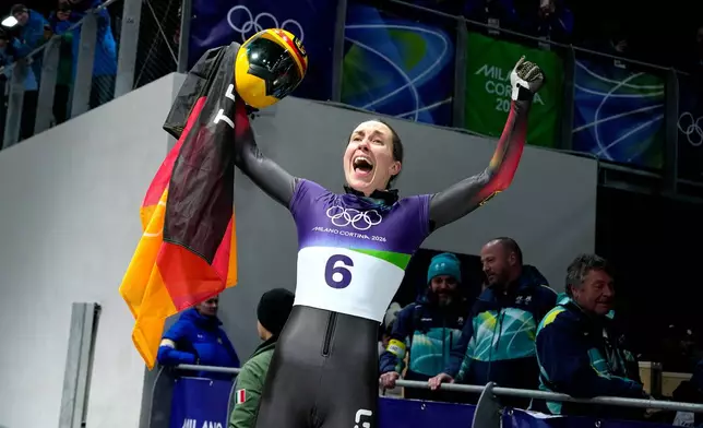 Germany's bronze medalist Jacqueline Pfeifer celebrates as she arrives at the finish during a women's skeleton run at the 2026 Winter Olympics, in Cortina d'Ampezzo, Italy, Saturday, Feb. 14, 2026. (AP Photo/Alessandra Tarantino)