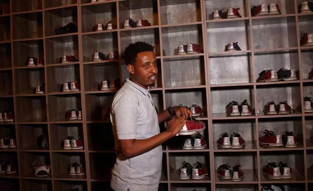 A Somali man selects a bowling shoe at the Feynuus Bowling Center in Mogadishu, Somalia, on Jan. 15, 2026. (AP Photo/Farah Abdi Warsameh)