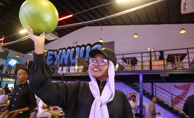 A Somali woman bowls at the Feynuus Bowling Center in Mogadishu, Somalia, on Jan. 15, 2026. (AP Photo/Farah Abdi Warsameh)