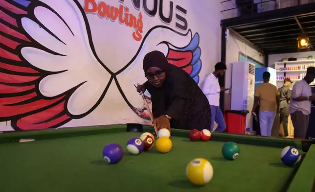 A Somali woman plays pool in Mogadishu, Somalia, on Jan. 15, 2026. (AP Photo/Farah Abdi Warsameh)