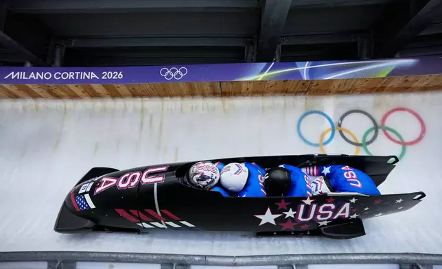 United States' Kristopher Horn, left, Caleb Furnell, Hunter Powell and Carsten Vissering slide down the track during a four man bobsled run at the 2026 Winter Olympics, in Cortina d'Ampezzo, Italy, Saturday, Feb. 21, 2026. (AP Photo/Aijaz Rahi)