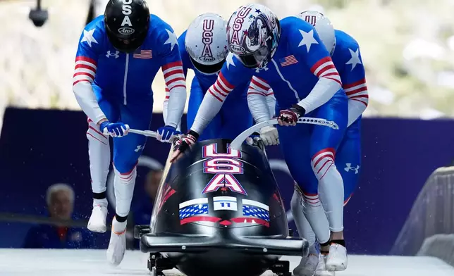 United States' Kristopher Horn, front, Caleb Furnell, Hunter Powell and Carsten Vissering start for a four man bobsled run at the 2026 Winter Olympics, in Cortina d'Ampezzo, Italy, Saturday, Feb. 21, 2026. (AP Photo/Alessandra Tarantino)