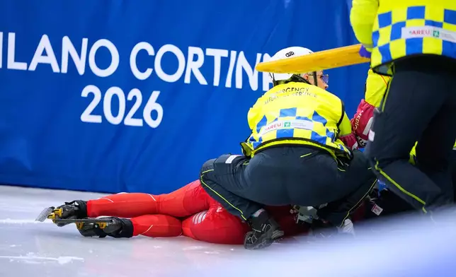 Kamila Sellier of Poland is helped after a fall during a short track speed skating women's 1500 meters quarterfinal at the 2026 Winter Olympics, in Milan, Italy, Friday, Feb. 20, 2026. (AP Photo/Natacha Pisarenko)