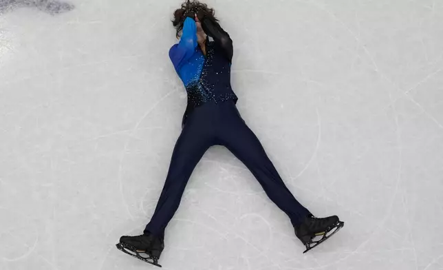 Mikhail Shaidorov of Kazakhstan reacts as he competes during the men's free skate program in figure skating at the 2026 Winter Olympics, in Milan, Italy, Friday, Feb. 13, 2026. (AP Photo/Christophe Ena)