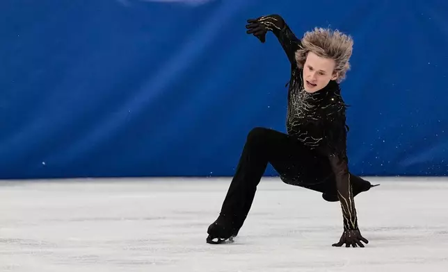 Ilia Malinin of the United States falls during the men's free skate program in figure skating at the 2026 Winter Olympics, in Milan, Italy, Friday, Feb. 13, 2026. (AP Photo/Ashley Landis)