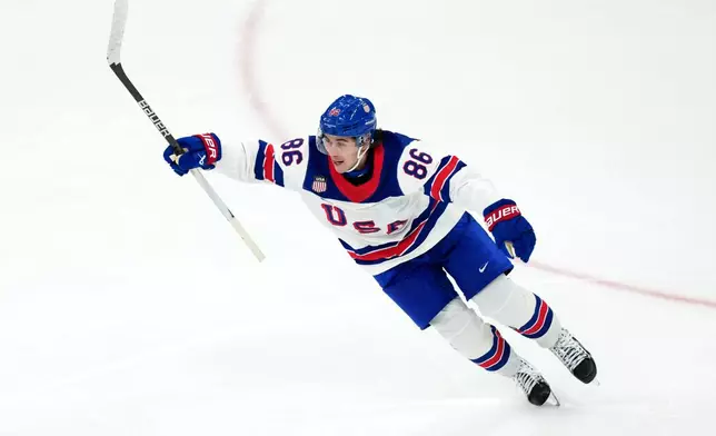 United States' Jack Hughes celebrates after scoring the winning goal against Canada during the overtime period of the men's ice hockey gold medal game at the 2026 Winter Olympics in Milan, Italy, Sunday, Feb. 22, 2026. (AP Photo/Carolyn Kaster)
