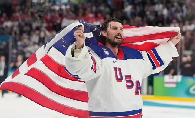 United States' Connor Hellebuyck (37) celebrate after defeating Canada during a men's ice hockey gold medal game between Canada and the United States at the 2026 Winter Olympics, in Milan, Italy, Sunday, Feb. 22, 2026. (AP Photo/Hassan Ammar)