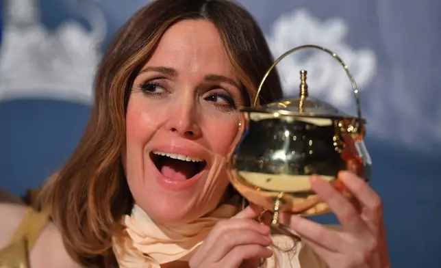 CORRECTS HALL SPELLING: Rose Byrne, Hasty Pudding 2026 Woman of the Year, displays the Pudding Pot poses for photos during a news conference at Farkas Hall theater, on the campus of Harvard University, Friday, Feb. 13, 2026, in Cambridge, Mass. (AP Photo/Steven Senne)