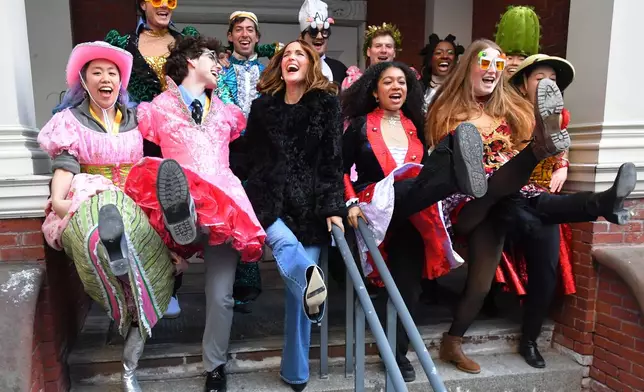 Rose Byrne, center, Hasty Pudding 2026 Woman of the Year, laughs while dancing with Harvard University theatrical students following a parade, Friday, Feb. 13, 2026, through Harvard Square, in Cambridge, Mass. (AP Photo/Steven Senne)