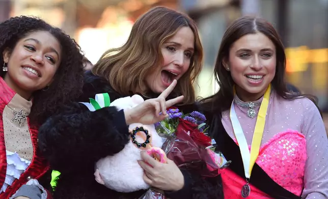 Rose Byrne, center, Hasty Pudding 2026 Woman of the Year, rides in a convertible with Harvard University theatrical students Isabel Wilson, left, and Daisy Nussbaum, right, during a parade, Friday, Feb. 13, 2026, through Harvard Square, in Cambridge, Mass. (AP Photo/Steven Senne)