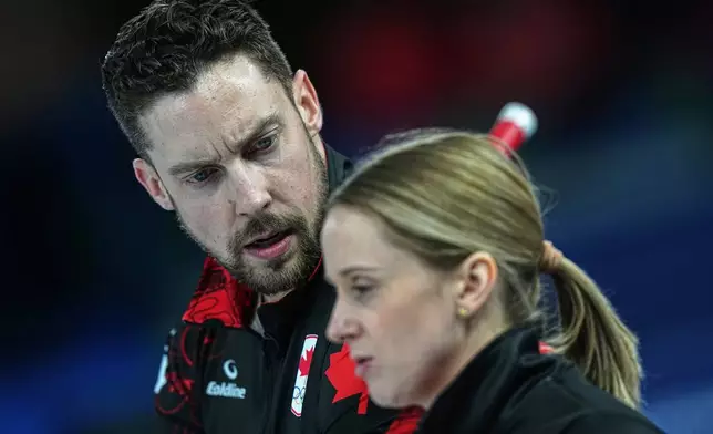 Canada's Brett Gallant and Jocelyn Peterman speak,during the mixed doubles round robin phase of the curling competition against Sweden, at the 2026 Winter Olympics, in Cortina d'Ampezzo, Italy, Sunday, Feb. 8, 2026. (AP Photo/Fatima Shbair)