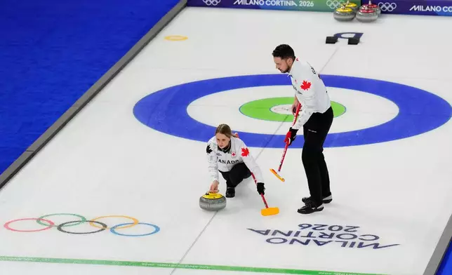 Jocelyn Peterman and Brett Gallant, of Canada, compete during a curling mixed doubles round robin session at the 2026 Winter Olympics, in Cortina d'Ampezzo, Italy, Friday, Feb. 6, 2026. (AP Photo/David J. Phillip)