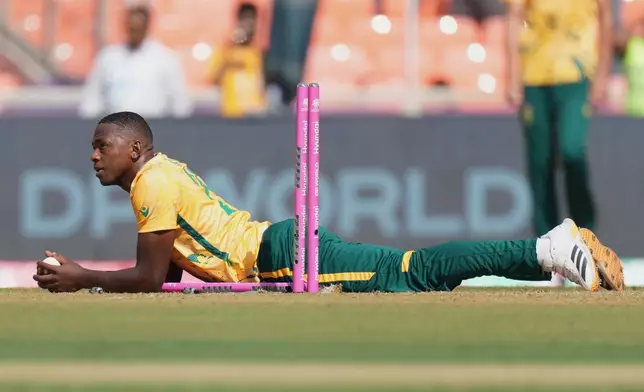 South Africa's Kagiso Rabada looks on with a ball as he run out Afghanistan's Fazalhaq Farooqi during the T20 World Cup cricket match between Afghanistan and South Africa in Ahmedabad, India, Wednesday, Feb. 11, 2026. (AP Photo/Ajit Solanki)