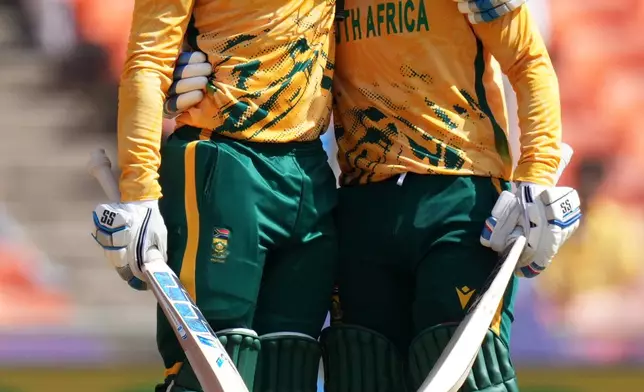 South Africa's Ryan Rickel, left with Quinton de Kock greet each other after scoring fifty runs during the T20 World Cup cricket match between Afghanistan and South Africa in Ahmedabad, India, Wednesday, Feb. 11, 2026. (AP Photo/Ajit Solanki)
