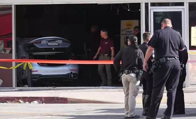 A car is seen inside of a 99 Ranch Market at the scene of a fatal crash Thursday, Feb. 5, 2026, in the Westwood neighborhood of Los Angeles.(AP Photo/Damian Dovarganes)