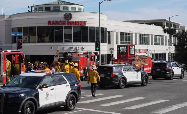 First responders work the scene of a fatal crash outside of a 99 Ranch Market, Thursday, Feb. 5, 2026, in the Westwood neighborhood of Los Angeles.(AP Photo/Damian Dovarganes)
