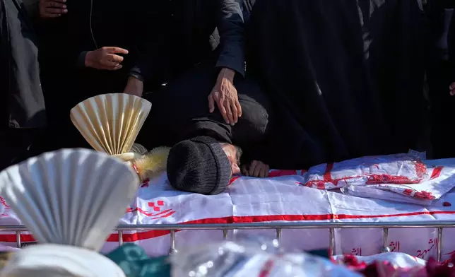 A man mourns over the coffin of his relative killed in Friday's suicide bombing inside a Shiite mosque, during a funeral prayer, in Islamabad, Pakistan, Saturday, Feb. 7, 2026. (AP Photo/Anjum Naveed)