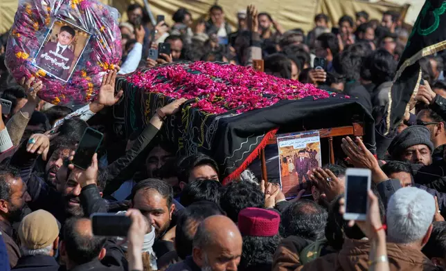 Mourners carry coffin of a child, who was killed in Friday's suicide bombing inside a Shiite mosque, for a funeral prayer, in Islamabad, Pakistan, Saturday, Feb. 7, 2026. (AP Photo/Anjum Naveed)