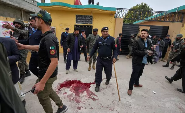 Pakistani security officers keep away the people from the site of a bomb explosion at a Shiite mosque, in Islamabad, Pakistan, Friday, Feb. 6, 2026. (AP Photo/Anjum Naveed)