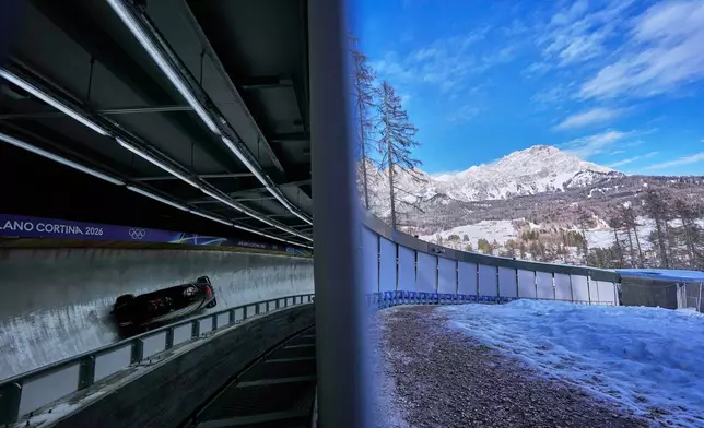 Canada's Bianca Ribi, right, slides down the track during a two women bobsled training session at the 2026 Winter Olympics, in Cortina d'Ampezzo, Italy, Wednesday, Feb. 18, 2026. (AP Photo/Alessandra Tarantino)