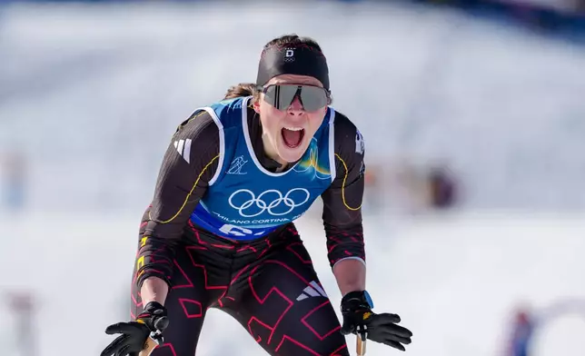 Coletta Rydzek, of Germany, reacts after crossing the finish line to win the bronze medal in the cross-country skiing women's team sprint free at the 2026 Winter Olympics, in Tesero, Italy, Wednesday, Feb. 18, 2026. (AP Photo/Kirsty Wigglesworth)