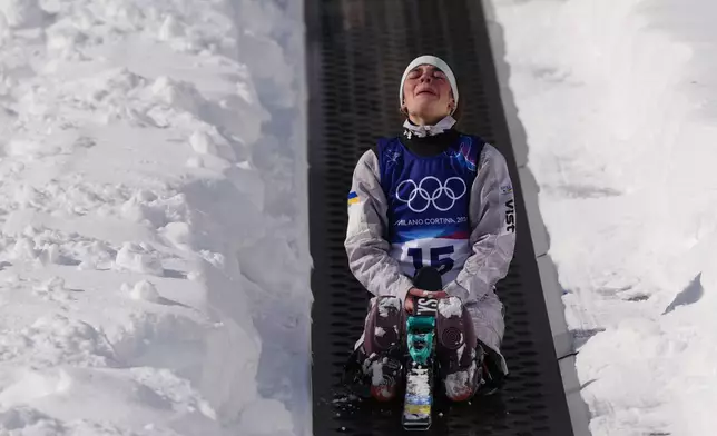 Ukraine's Anhelina Brykina (15) reacts as she rides up the magic carpet during the women's freestyle skiing aerials qualifications at the 2026 Winter Olympics, in Livigno, Italy, Wednesday, Feb. 18, 2026. (AP Photo/Julia Demaree Nikhinson)