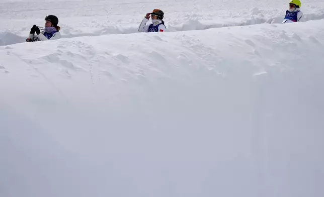 Athletes ride the magic carpet before the women's freestyle skiing aerials finals at the 2026 Winter Olympics, in Livigno, Italy, Wednesday, Feb. 18, 2026. (AP Photo/Julia Demaree Nikhinson)