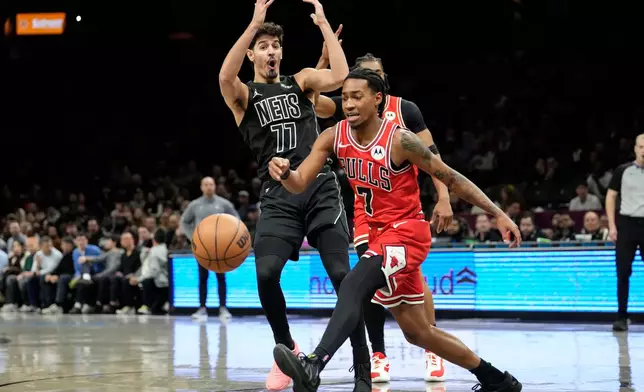 Brooklyn Nets guard Ben Saraf (77) reacts as he gets fouled during the first half of an NBA basketball game against the Chicago Bulls, Monday, Feb. 9, 2026, in New York. (AP Photo/Yuki Iwamura)