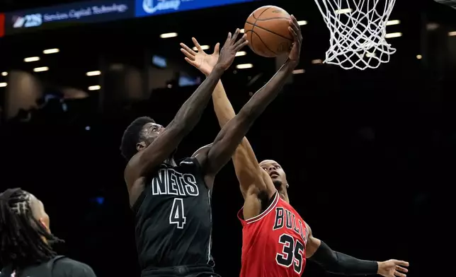 Brooklyn Nets guard Drake Powell (4) is blocked by Chicago Bulls forward Isaac Okoro (35) during the first half of an NBA basketball game, Monday, Feb. 9, 2026, in New York. (AP Photo/Yuki Iwamura)