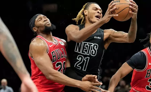 Brooklyn Nets forward Noah Clowney (21) is hit by Chicago Bulls forward Guerschon Yabusele, left, during the first half of an NBA basketball game, Monday, Feb. 9, 2026, in New York. (AP Photo/Yuki Iwamura)
