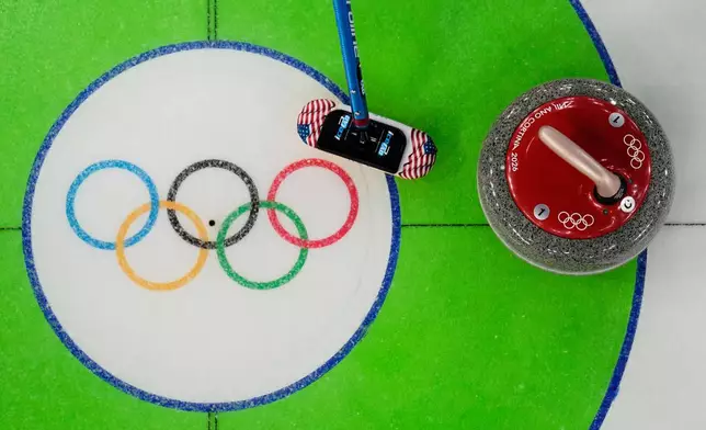 United States' Taylor Anderson-Heide sweeps near a stone during a women's curling round robin match against Denmark at the 2026 Winter Olympics, in Cortina d'Ampezzo, Italy, Tuesday, Feb. 17, 2026. (AP Photo/David J. Phillip)