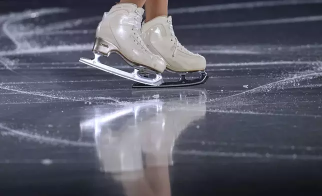 Yuna Nagaoka and Sumitada Moriguchi of Japan warm up before the pairs figure skating short program at the 2026 Winter Olympics, in Milan, Italy, Sunday, Feb. 15, 2026. (AP Photo/Ashley Landis)