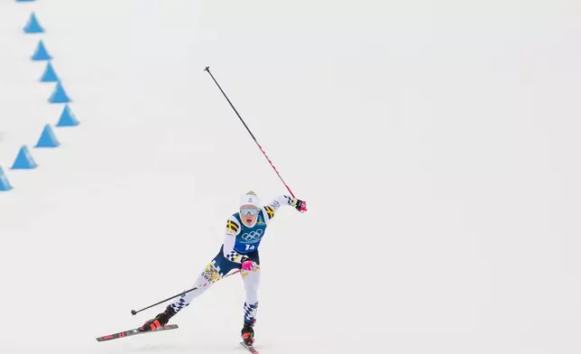 Jonna Sundling, of Sweden, approaches the finish line in the cross country skiing women's 4 x 7.5km relay at the 2026 Winter Olympics, in Tesero, Italy, Saturday, Feb. 14, 2026. (AP Photo/Evgeniy Maloletka)