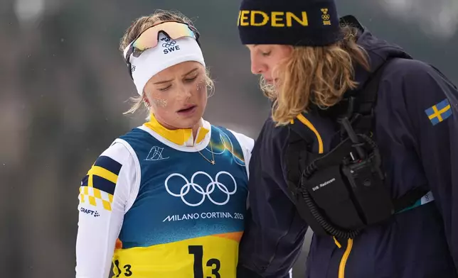 Frida Karlsson, of Sweden, walks off the course after completing her leg of the cross country skiing women's 4 x 7.5km relay at the 2026 Winter Olympics, in Tesero, Italy, Saturday, Feb. 14, 2026. (AP Photo/Matthias Schrader)