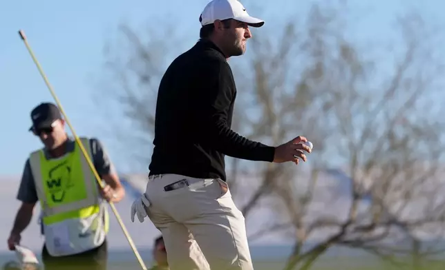 Scottie Scheffler waves to the crowd after getting a birdie on the 10th hole during the first round of the Phoenix Open golf tournament at the TPC Scottsdale Stadium Course Thursday, Feb. 5, 2026, in Scottsdale, Ariz. (AP Photo/Ross D. Franklin)