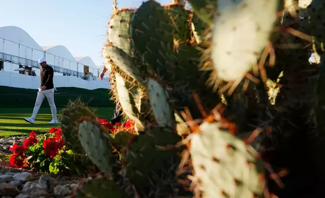 Scottie Scheffler walks to the 10th tee during the first round of the Phoenix Open golf tournament at the TPC Scottsdale Stadium Course Thursday, Feb. 5, 2026, in Scottsdale, Ariz. (AP Photo/Ross D. Franklin)