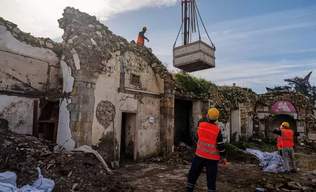Workers clear rubble and salvage stones from the ruins of St. Paul's Greek Orthodox Church, damaged in the 2023 earthquake, in the city of Antakya, southern Turkey, Wednesday, Feb. 4, 2026. (AP Photo/Murat Kocabas)