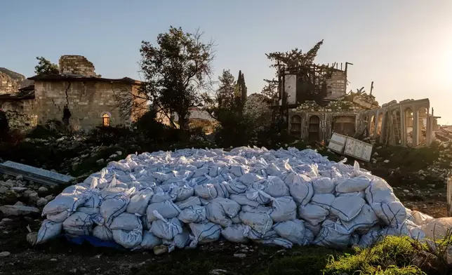 Sacks of rubble removed from the ruins of St. Paul's Greek Orthodox Church, heavily damaged in the February 2023 earthquake, are placed at the site in Antakya, southern Turkey, Wednesday, Feb. 4, 2026. (AP Photo/Murat Kocabas)
