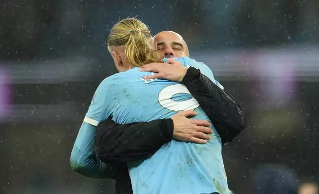 Manchester City's head coach Pep Guardiola hugs Erling Haaland after the English Premier League soccer match between Manchetser City nad Newcastle in Manchester, England, Saturday, Feb. 21, 2026. (AP Photo/Jon Super)