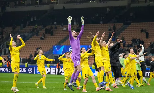 Glimt's players celebrate at the end of the Champions League playoff soccer match between Inter Milan and Bodo Glimt, at the San Siro stadium in Milan, Italy, Tuesday, Feb.24, 2026. (AP Photo/Luca Bruno)