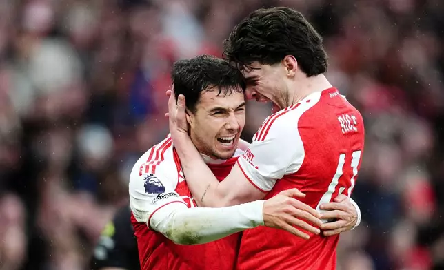 Arsenal's Martin Zubimendi, left, celebrates scoring with Declan Rice during the English Premier League soccer match between Arsenal and Sunderland in London, Saturday Feb. 7, 2026. (John Walton/PA via AP)