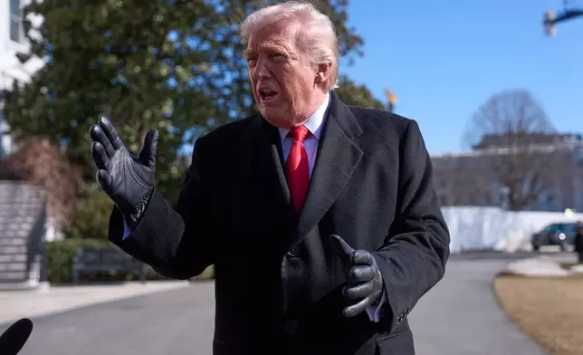 President Donald Trump speaks with reporters before boarding Marine One on the South Lawn of the White House, Friday, Feb. 13, 2026, in Washington. (AP Photo/Evan Vucci)