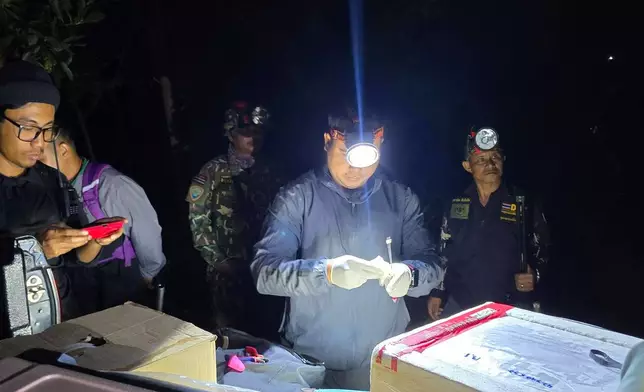 In this photo released by Thailand Department of National Parks, Wildlife and Plant Conservation, officials prepare elephant contraception vaccines for wild elephants in the Trat province of Thailand, Monday, Jan. 26, 2026. (Thailand Department of National Parks, Wildlife and Plant Conservation via AP)