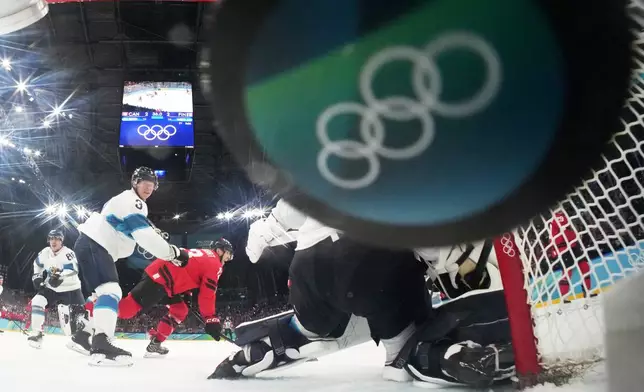 Canada's Nathan MacKinnon, not seen, scores his side's third goal during a men's ice hockey semifinal game between Canada and Finland at the 2026 Winter Olympics, in Milan, Italy, Friday, Feb. 20, 2026. (Mike Segar/Pool Photo via AP)