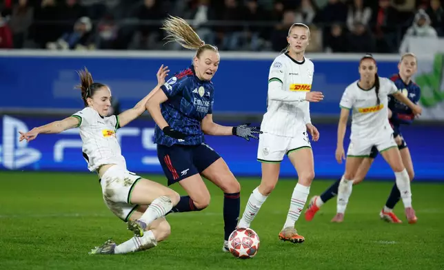 Leuven's Zenia Mertens, left, fights for the ball with Arsenal's Frida Maanum, second left, during the women's Champions League knockout play-off soccer match between OH Leuven and Arsenal in Leuven, Belgium, Wednesday, Feb. 11, 2026. (AP Photo/Geert Vanden Wijngaert)