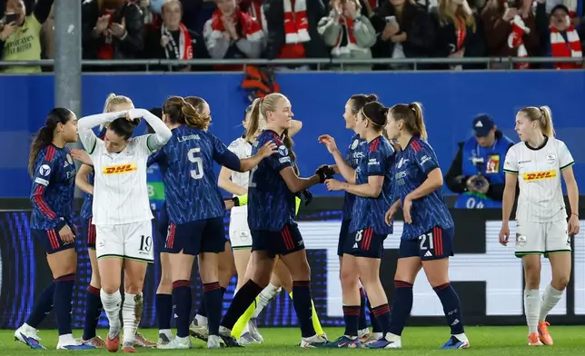 Arsenal players celebrate after Arsenal's Frida Maanum scored the opening goal during the women's Champions League knockout play-off soccer match between OH Leuven and Arsenal in Leuven, Belgium, Wednesday, Feb. 11, 2026. (AP Photo/Geert Vanden Wijngaert)
