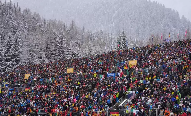 Spectators watch the men's 4x7.5-kilometer relay biathlon race at the 2026 Winter Olympics in Anterselva, Italy, Tuesday, Feb. 17, 2026. (AP Photo/Mosa'ab Elshamy)