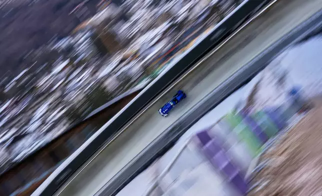 Italy's Simona de Silvestro slides down the track during a two women bobsled training session at the 2026 Winter Olympics, in Cortina d'Ampezzo, Italy, Tuesday, Feb. 17, 2026. (AP Photo/Alessandra Tarantino)