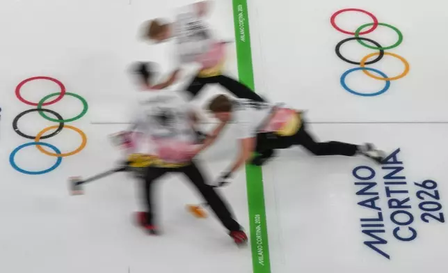 Germany's Benjamin Kapp, Felix Messenzehl, and Johannes Scheuerl in action during the men's curling round robin session against Czechia, at the 2026 Winter Olympics, in Cortina d'Ampezzo, Italy, Tuesday, Feb. 17, 2026. (AP Photo/Misper Apawu)